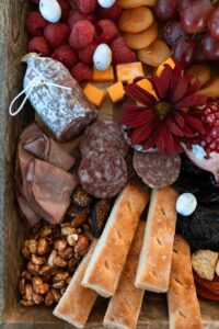 A rustic charcuterie board featuring cured meats, cheeses, nuts, and fresh fruits, perfect for food lovers.